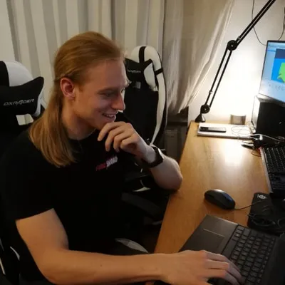 Matthias Dafert at his desk in a Fire Sword Studios shirt